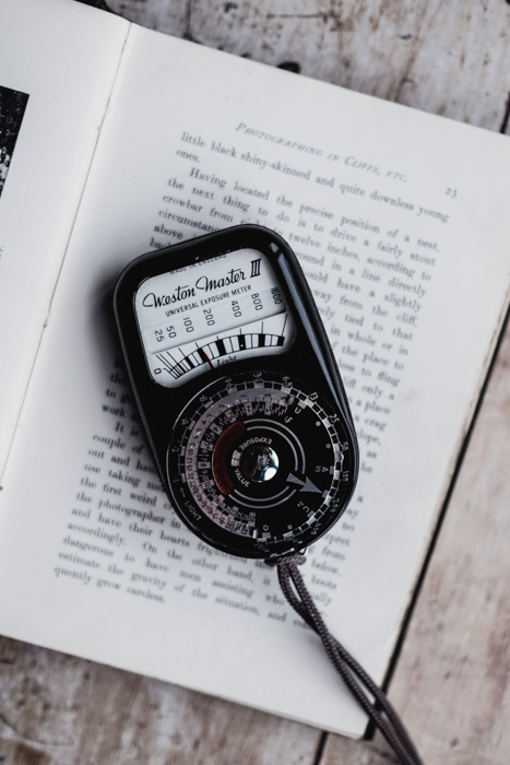 Photo of a handheld light meter on a book. Tips for Light Meter Photography